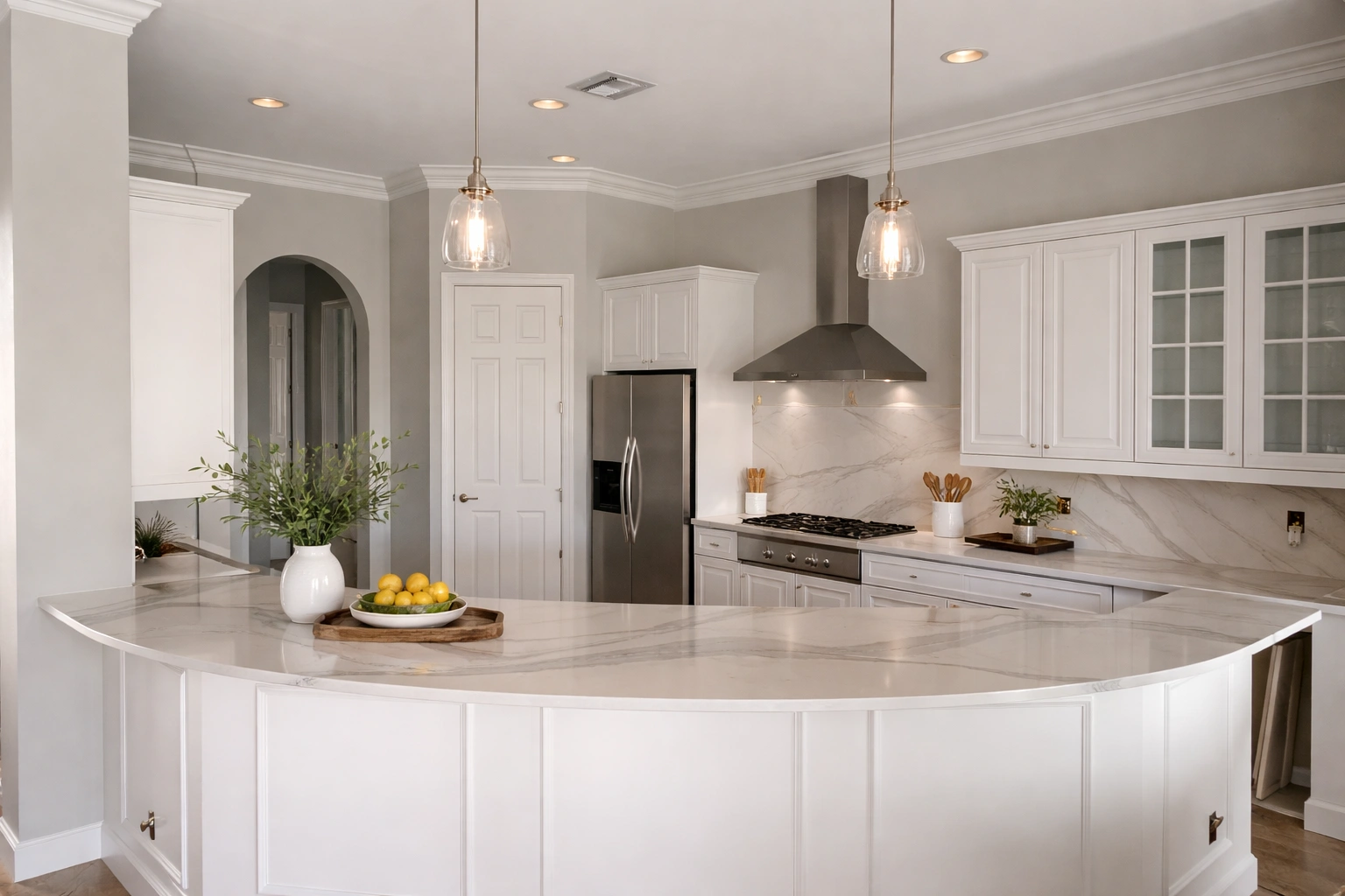 White kitchen — curved marble peninsula as focal point