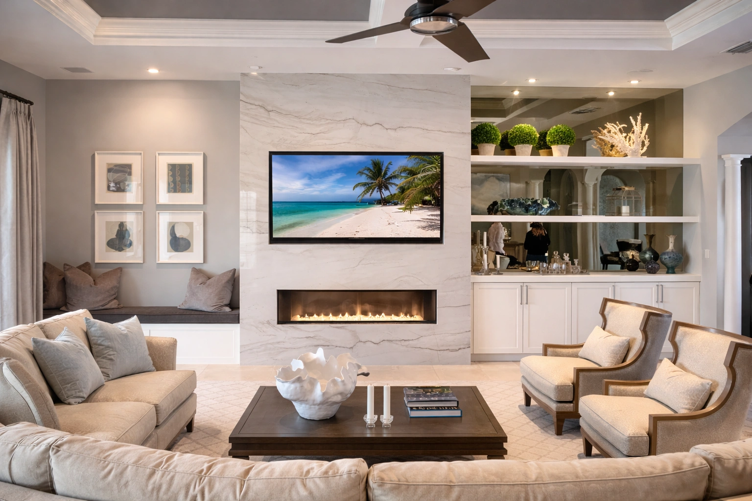 Luxury living room — floor-to-ceiling marble fireplace wall, built-in shelves, coastal decor