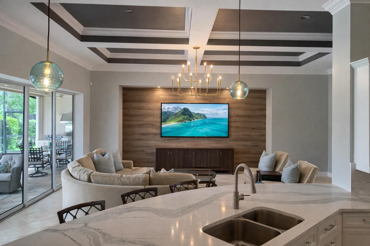 Open plan living/kitchen — marble island in foreground, living area beyond, tall ceilings